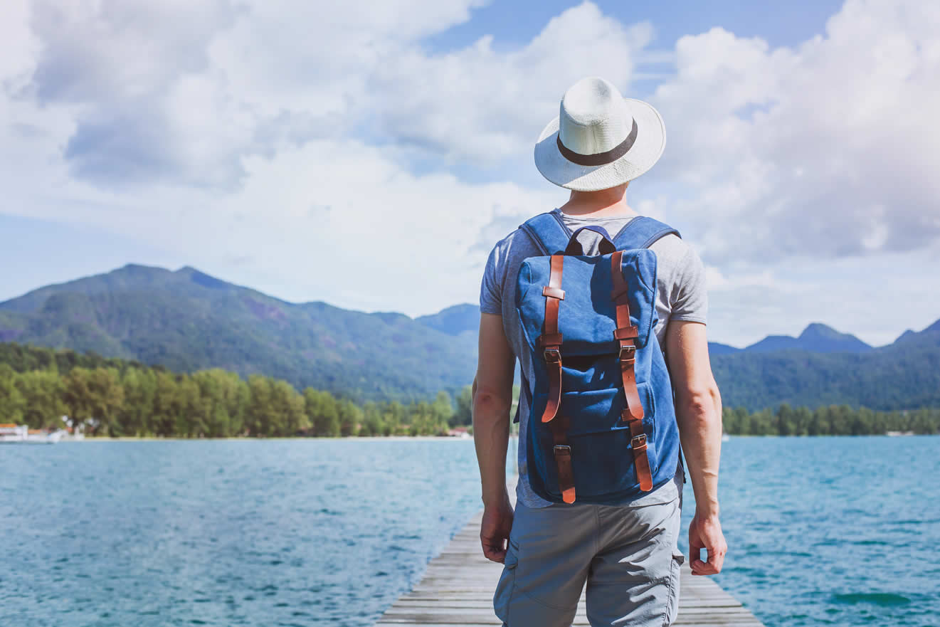 Man on jetty looking out over a lake