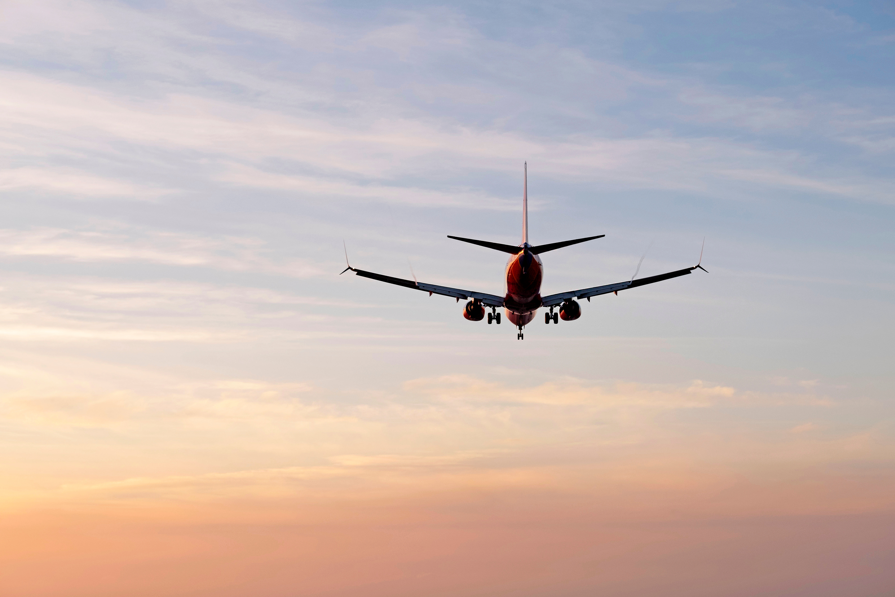 Plane flying off into sunset