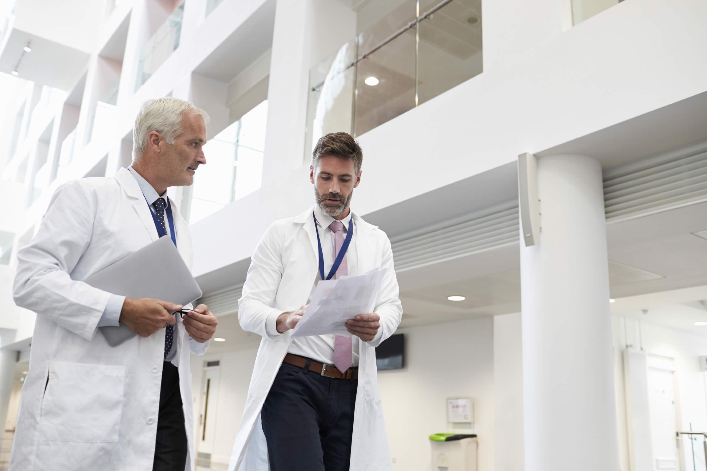 Male doctors walking down corridor