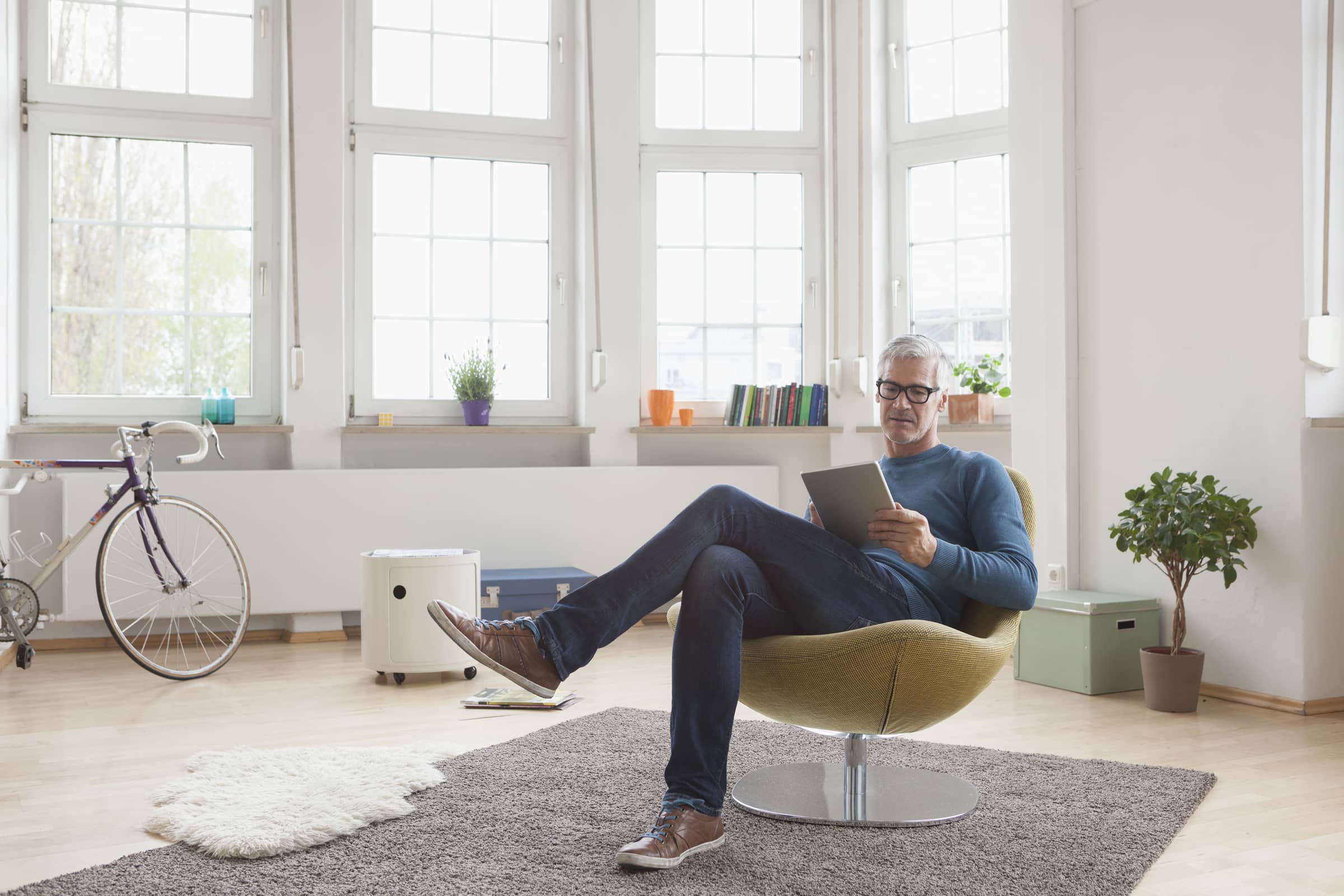 Man sitting down looking at tablet