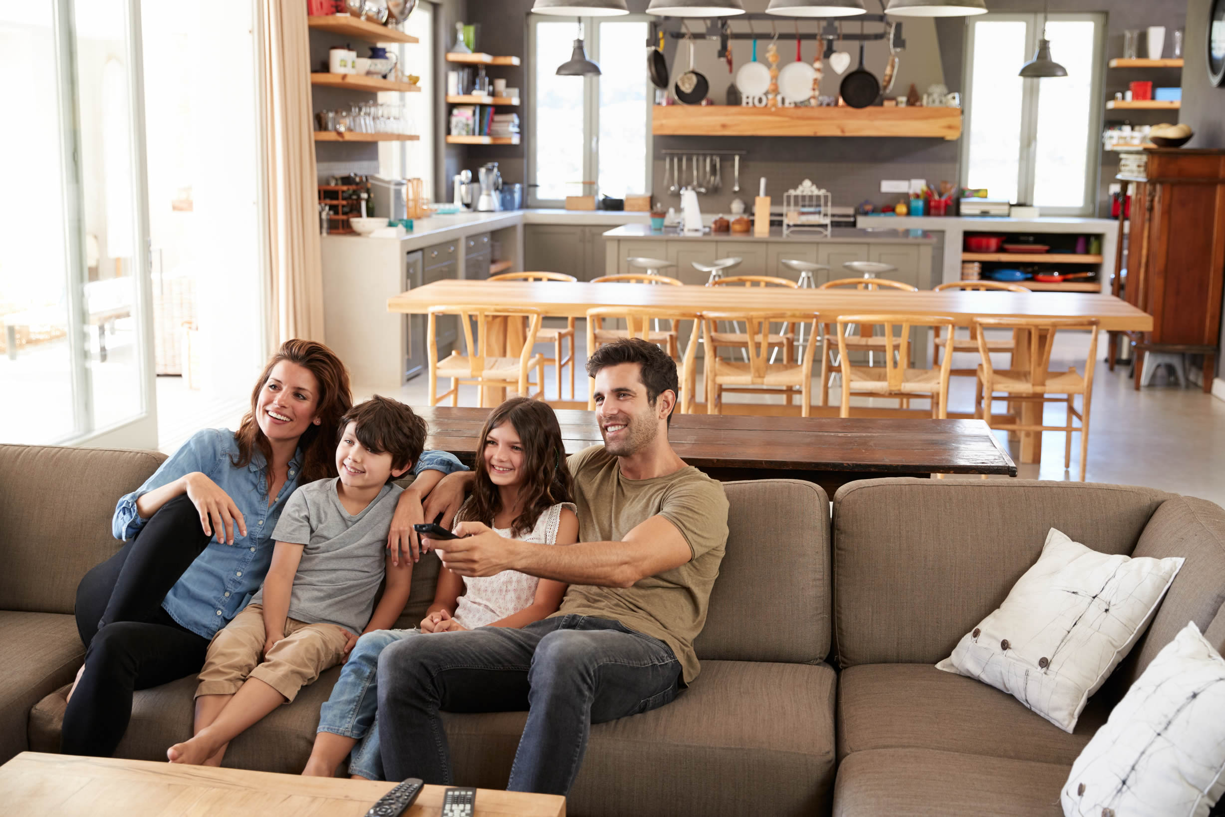 Family sat together on sofa