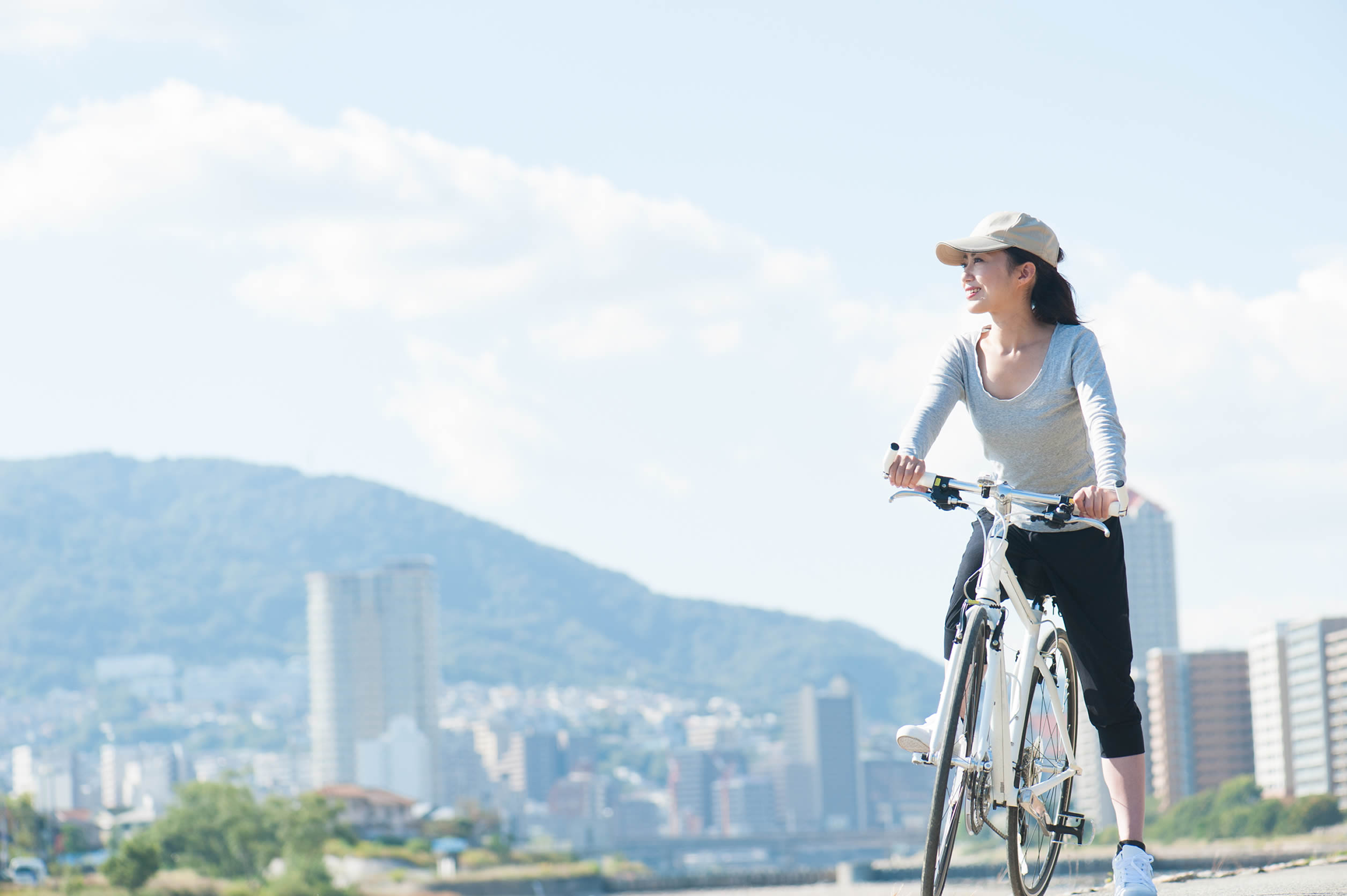 Woman on bike with city background